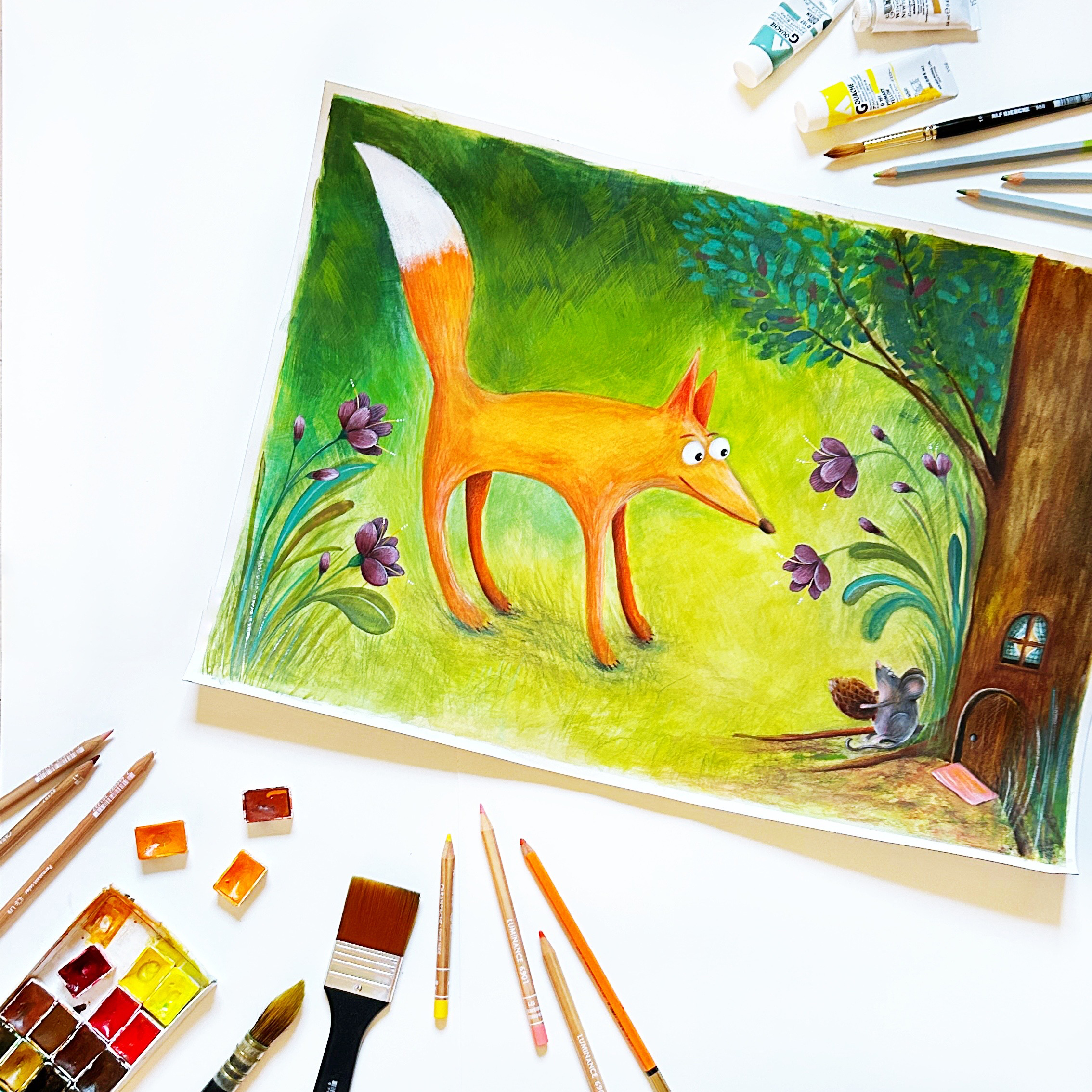 Illustration with a fox meeting a mouse in the woods. The artwork is surrounded by paint and colored pencils.